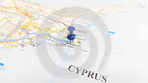 A blue board pin stuck in Ayia Napa on a map of Cyprus