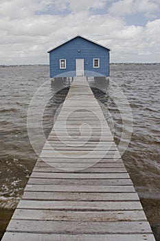 Blue boat house on river