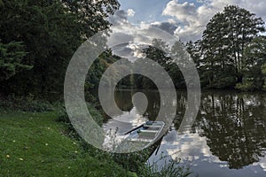 Blue boat moored at the bank of the river