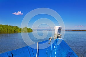 Blue boat sailing in Albufera lake of Valencia photo