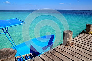 Blue boat in wooden tropical pier in Caribbean