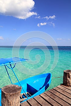 Blue boat in wooden tropical pier in Caribbean