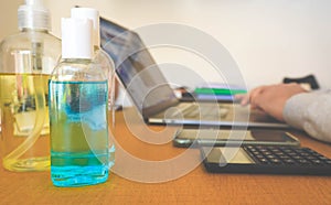 Blue bottles of hand sanitiser on a table