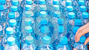 Blue bottles with pure clear water prepared for drinking