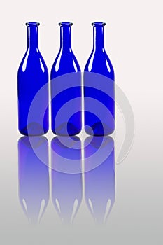Blue bottles with reflection isolated on white background
