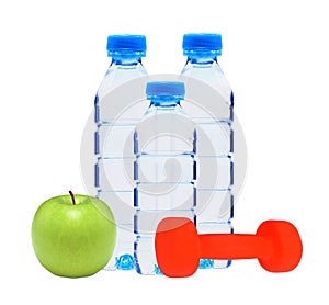 Blue bottles with water, dumbell and green apple