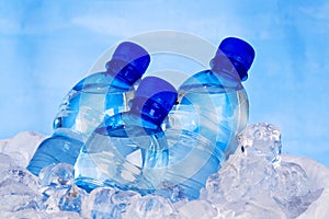 Blue bottles of water in ice