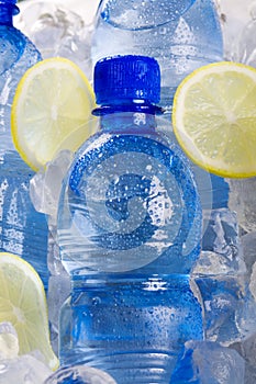 Blue bottles of water in ice