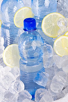 Blue bottles of water in ice