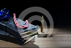 Blue bow and candy cane on top of polymer assault rifle magazines
