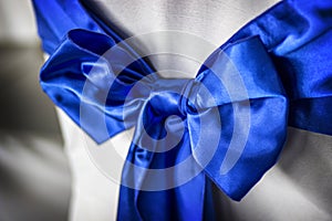 Blue Bow and Sash on Chair at Event or Reception photo