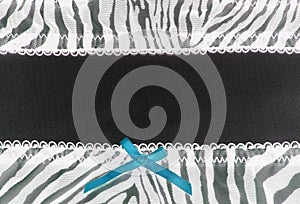 Blue bow and zebra pattern textile frame with dark canvas negative effect design