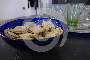 Blue bowk of crackers with glasses for drinks