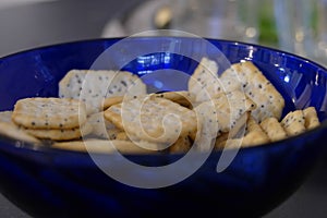 Blue bowk of crackers with glasses for drinks