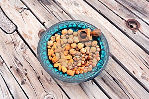 Blue bowl containing different nuts