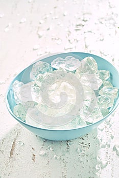 Blue bowl filled with frozen ice cubes