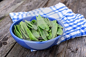 Blue bowl with green peapods