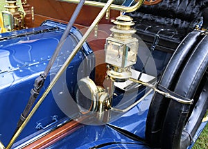 Detail of a blue brass era antique car