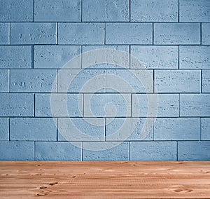 Blue brick background and wooden floor
