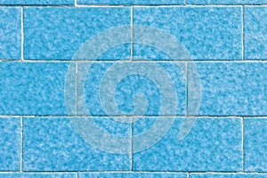 Blue brick stone wall of symmetrical blocks with spots