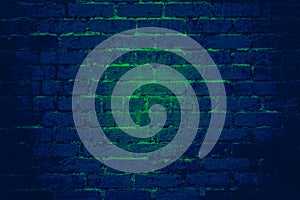 Blue brick wall background texture with green light shining through cracks