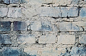 Blue brick wall with cracks and scuffs, urban loft background
