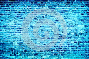 Blue brick wall painted with different tones and hues of blue as seamless pattern texture background