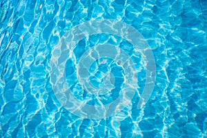 Blue and bright ripple water and surface in swimming pool. Beautiful motion wave in pool