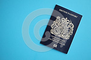 Blue British passport on blue background close up