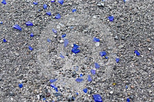 Blue broken glass on the asphalt