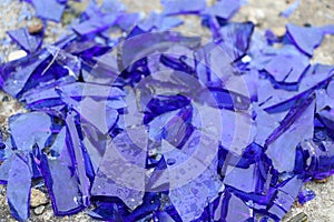 Blue broken glass on a concrete surface - texture for a background, design