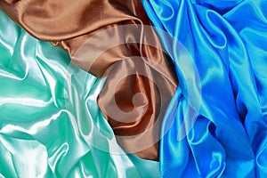 Blue and brown and light green silk satin cloth of wavy folds te