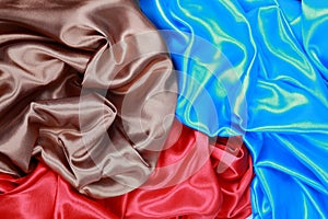 Blue and brown and red silk satin cloth of wavy folds texture ba