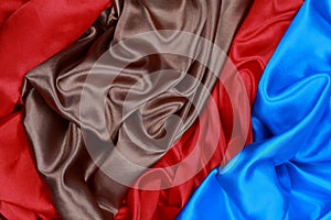 Blue and brown and red silk satin cloth of wavy folds texture ba