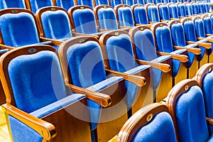 Blue brown wooden chairs in the auditorium. Without people