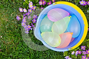 Blue bucket with water balloons