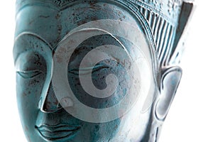 Blue Buddha face. Contemporary spiritual lifestyle close-up. Soft selective focus