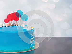 Blue buttercream Birthday cake with colorful lollipops