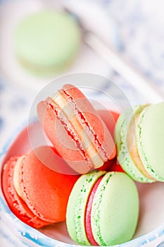 Blue butterfly tea and green and orange macaroons or macarons