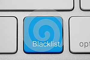 Blue button with word Blacklist on computer keyboard, closeup