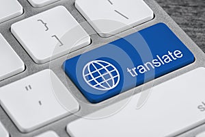 Blue button with word TRANSLATE on computer keyboard, closeup view
