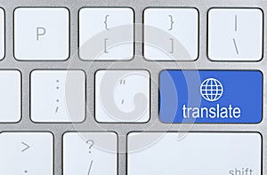Blue button with word TRANSLATE on computer keyboard, top view