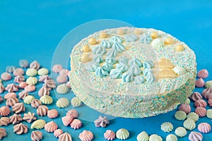 blue cake for babyshower party with meringue. Homemade cake for a newborn boy On a blue background.