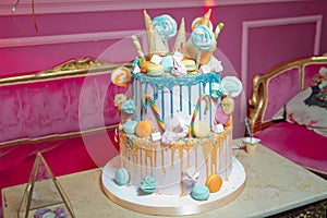 Blue cake with colorfull small sweet ball . decoration for cake and bekery. Colorfull cake pops in waffle cone for ice cream in