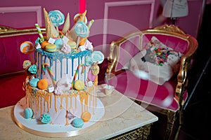 Blue cake with colorfull small sweet ball . decoration for cake and bekery. Colorfull cake pops in waffle cone for ice cream in