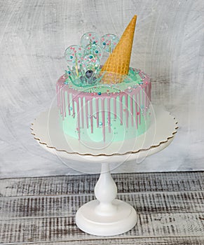 Blue cake with ice cream cone and caramel decoration