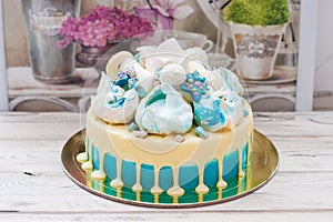Blue cake with white melted chocolate, meringue, fondant crown and marshmallows.
