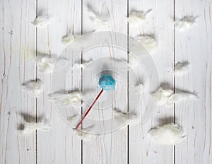 Blue cakepops among the candy-floss clouds, white background