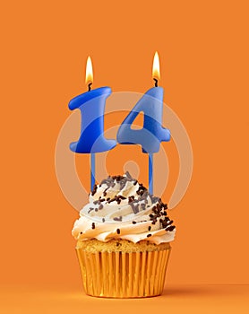 Blue candle number 14 - Birthday cupcake on orange background