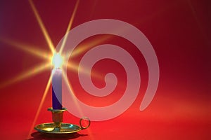 Blue candle on red background.
